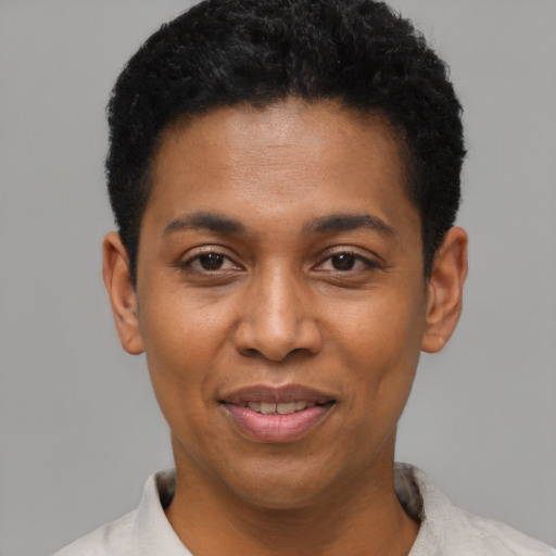 Joyful black young-adult male with short  black hair and brown eyes