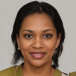 Joyful black young-adult female with medium  brown hair and brown eyes