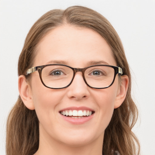 Joyful white young-adult female with long  brown hair and blue eyes