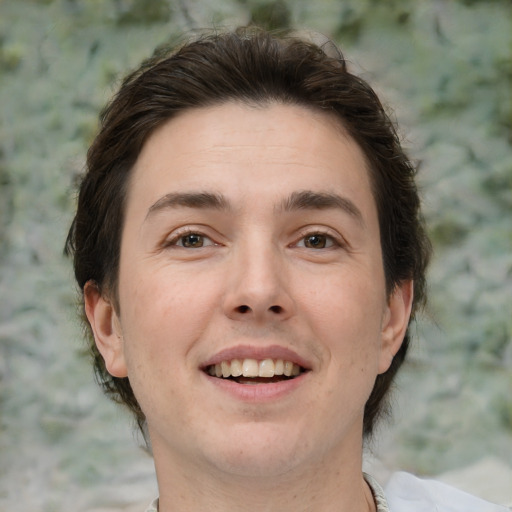 Joyful white adult male with medium  brown hair and brown eyes