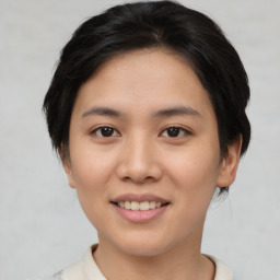 Joyful asian young-adult female with short  black hair and brown eyes