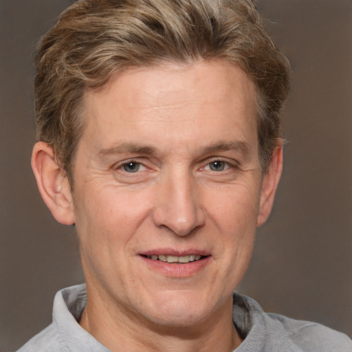 Joyful white adult male with short  brown hair and grey eyes