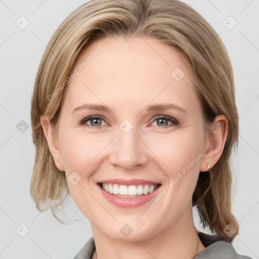 Joyful white young-adult female with medium  brown hair and blue eyes