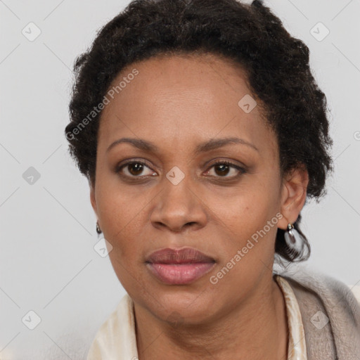 Joyful black adult female with short  brown hair and brown eyes