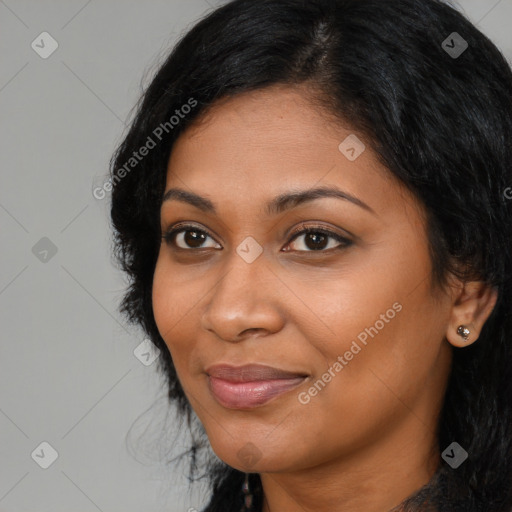 Joyful black young-adult female with long  black hair and brown eyes