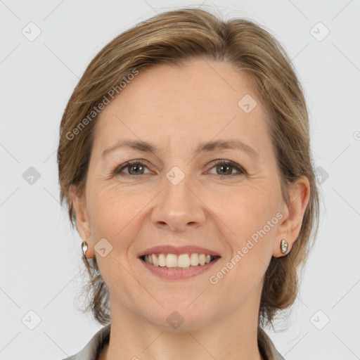 Joyful white adult female with medium  brown hair and grey eyes