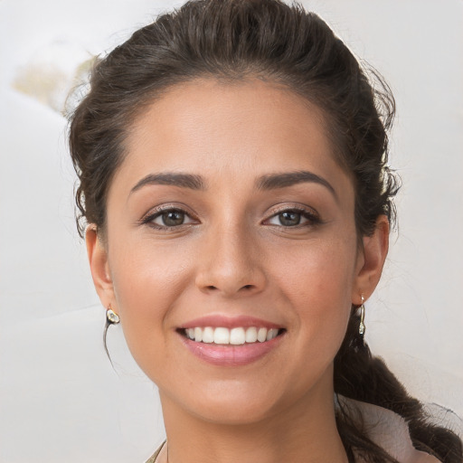 Joyful white young-adult female with medium  brown hair and brown eyes