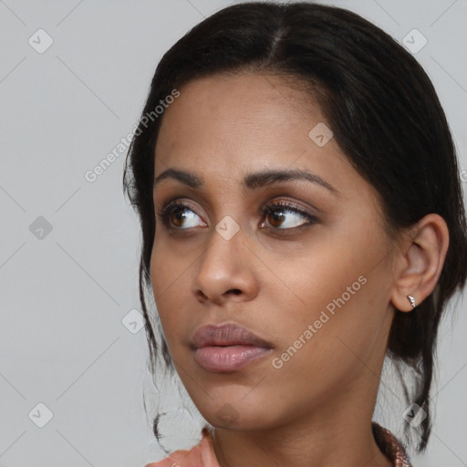 Neutral black young-adult female with medium  brown hair and brown eyes