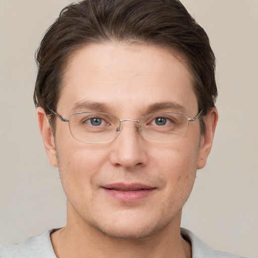 Joyful white adult male with short  brown hair and grey eyes