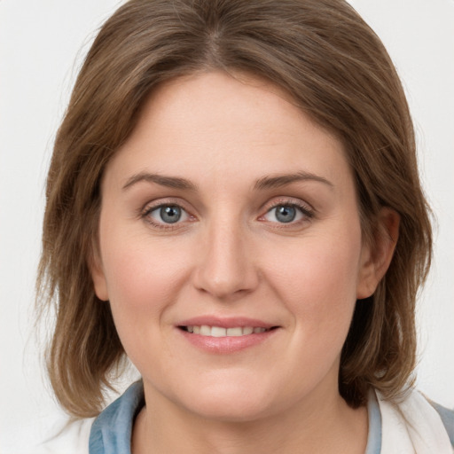 Joyful white young-adult female with medium  brown hair and blue eyes