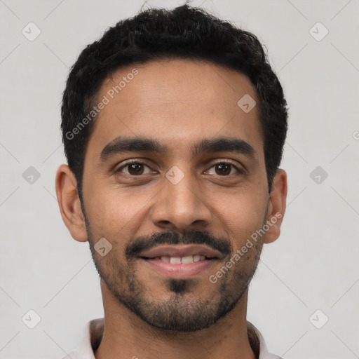 Joyful latino young-adult male with short  black hair and brown eyes