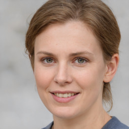 Joyful white young-adult female with medium  brown hair and blue eyes