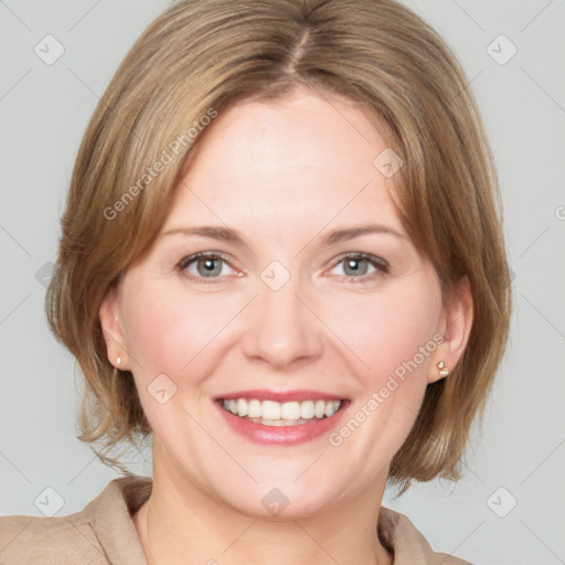 Joyful white young-adult female with medium  brown hair and blue eyes