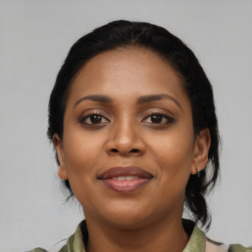 Joyful black young-adult female with medium  black hair and brown eyes