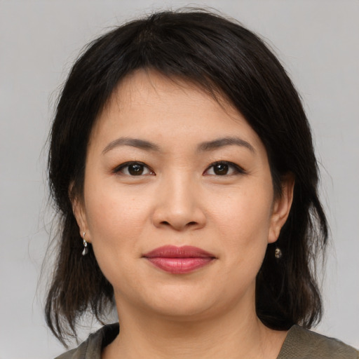 Joyful asian young-adult female with medium  brown hair and brown eyes