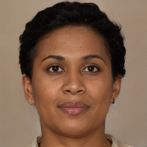 Joyful latino adult female with short  brown hair and brown eyes