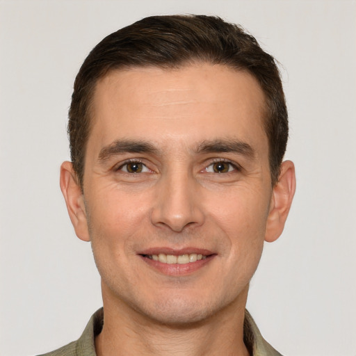 Joyful white young-adult male with short  brown hair and brown eyes