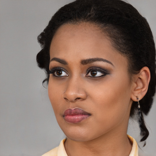 Joyful black young-adult female with medium  brown hair and brown eyes