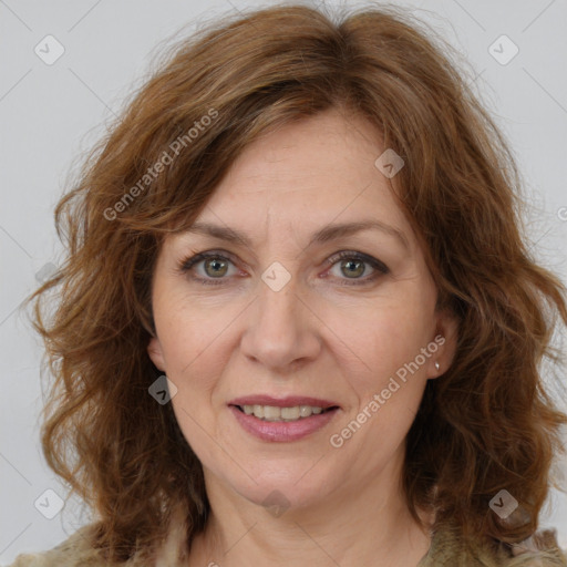 Joyful white adult female with medium  brown hair and green eyes