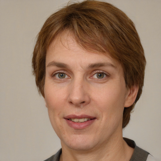 Joyful white adult female with medium  brown hair and grey eyes