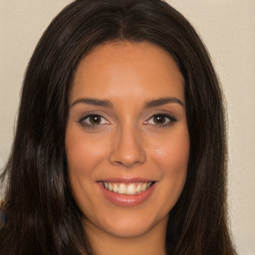 Joyful latino young-adult female with long  brown hair and brown eyes