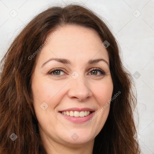 Joyful white adult female with long  brown hair and brown eyes