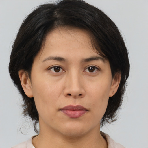 Neutral asian adult female with medium  brown hair and brown eyes