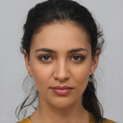 Joyful latino young-adult female with medium  brown hair and brown eyes