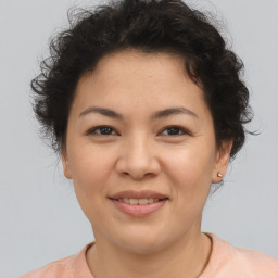 Joyful asian young-adult female with short  brown hair and brown eyes