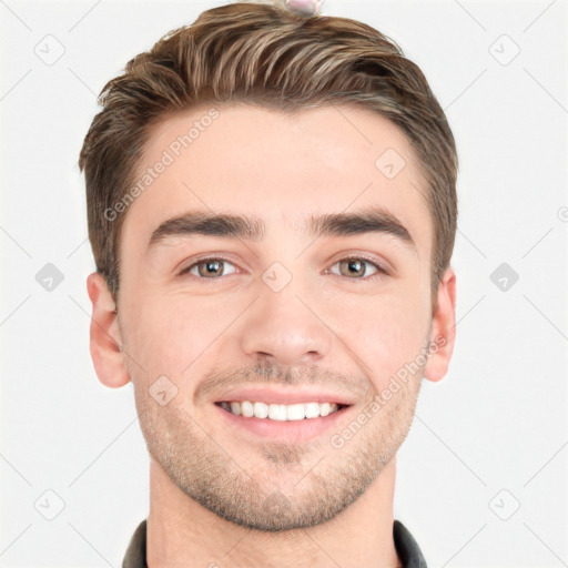 Joyful white young-adult male with short  brown hair and grey eyes