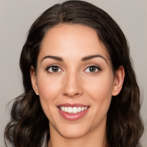 Joyful white young-adult female with long  brown hair and brown eyes