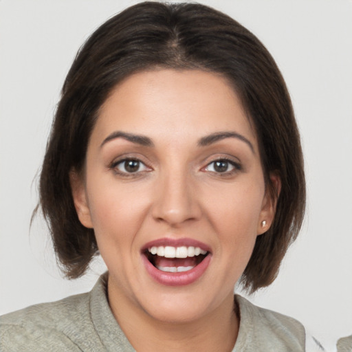 Joyful white young-adult female with medium  brown hair and brown eyes