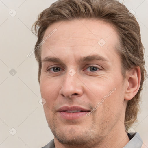 Joyful white adult male with short  brown hair and grey eyes