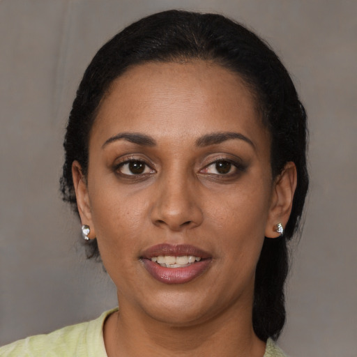 Joyful black young-adult female with short  brown hair and brown eyes