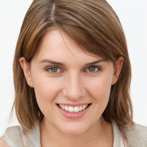 Joyful white young-adult female with medium  brown hair and green eyes