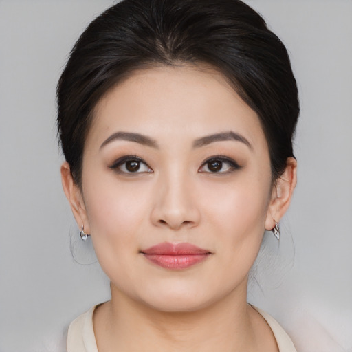Joyful asian young-adult female with medium  brown hair and brown eyes