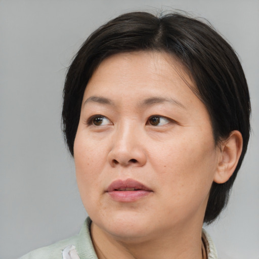 Neutral asian adult female with medium  brown hair and brown eyes