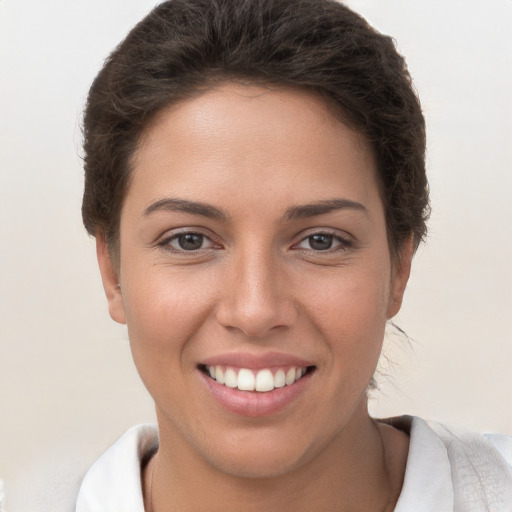 Joyful white young-adult female with short  brown hair and brown eyes