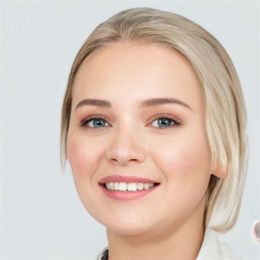 Joyful white young-adult female with medium  brown hair and blue eyes