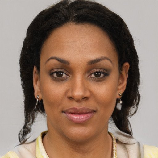 Joyful latino young-adult female with medium  brown hair and brown eyes