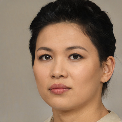 Joyful asian young-adult female with medium  brown hair and brown eyes