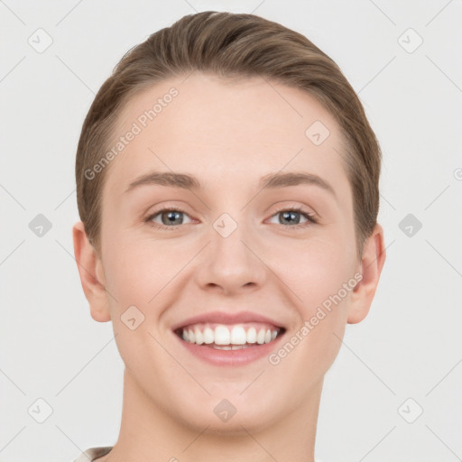 Joyful white young-adult female with short  brown hair and grey eyes