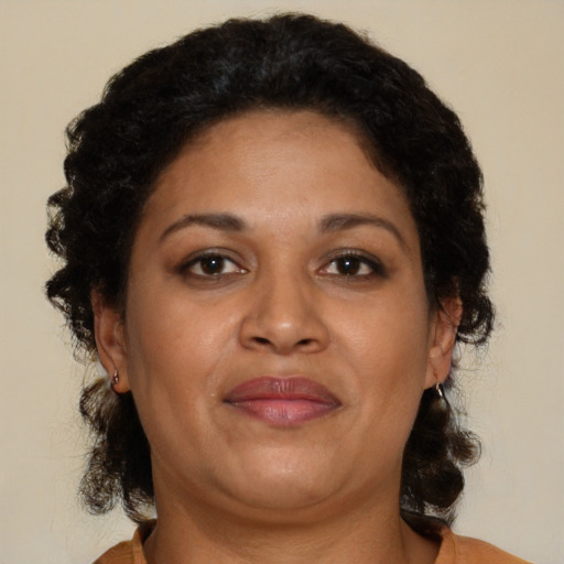 Joyful black adult female with medium  brown hair and brown eyes