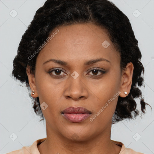 Joyful black adult female with medium  brown hair and brown eyes