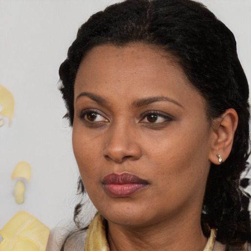 Neutral black young-adult female with long  brown hair and brown eyes