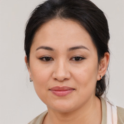 Joyful asian young-adult female with medium  brown hair and brown eyes