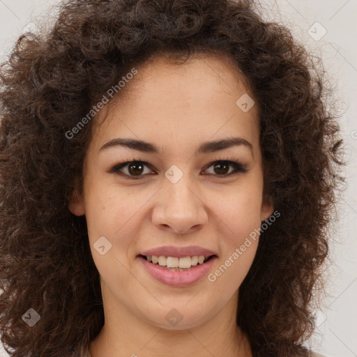 Joyful black young-adult female with long  brown hair and brown eyes