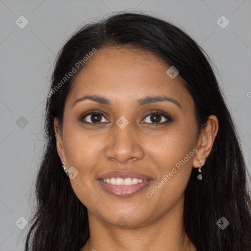 Joyful black young-adult female with long  brown hair and brown eyes