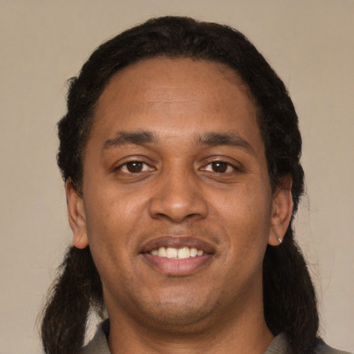 Joyful black adult male with short  black hair and brown eyes