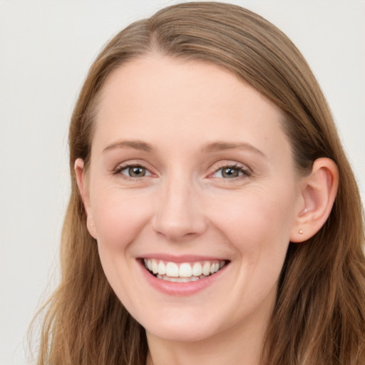 Joyful white young-adult female with long  brown hair and blue eyes